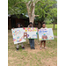 three young kids displaying their hai group poster contest submissions