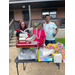  Volunteers behind snowcone table 
