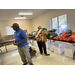  Resident inside Farmers Market room with fruits and veggies on table 