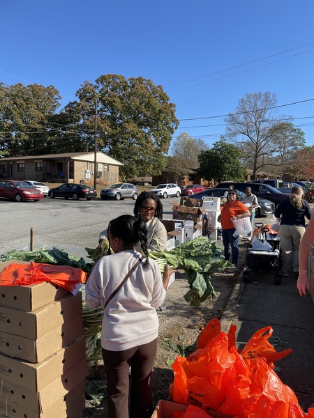 Individuals receiving fresh fruit and veggies at Farmers Market
