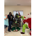  The Grinch and Santa with residents near the Christmas tree 