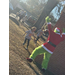  The Grinch surprising youth residents outside as he appears from behind a tree 
