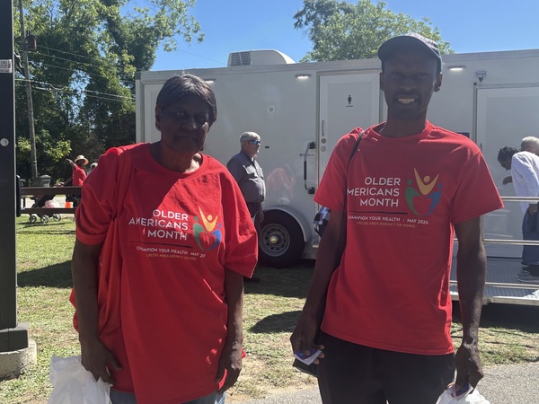 Older american celebration attendees from Auburn Housing Authority posed in their red event shirts